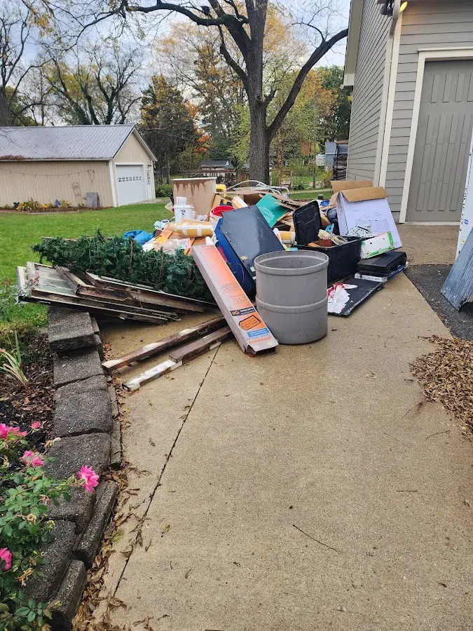 Dumpster being loaded with debris for Estate Cleanout Dumpster Rental in Penns Grove